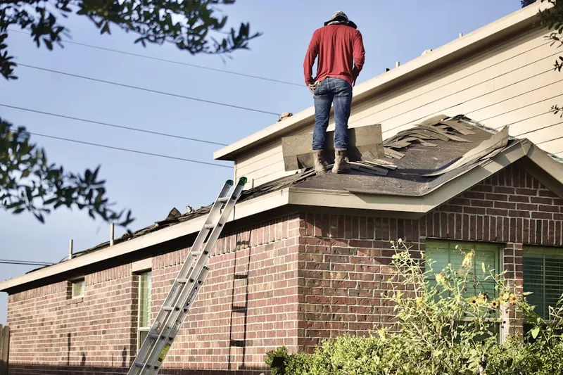 Professional roofer working on a residential roof in Crownridge of Texas
